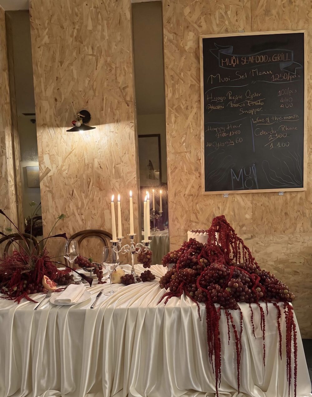Draped silk table with cascading grapes and candles