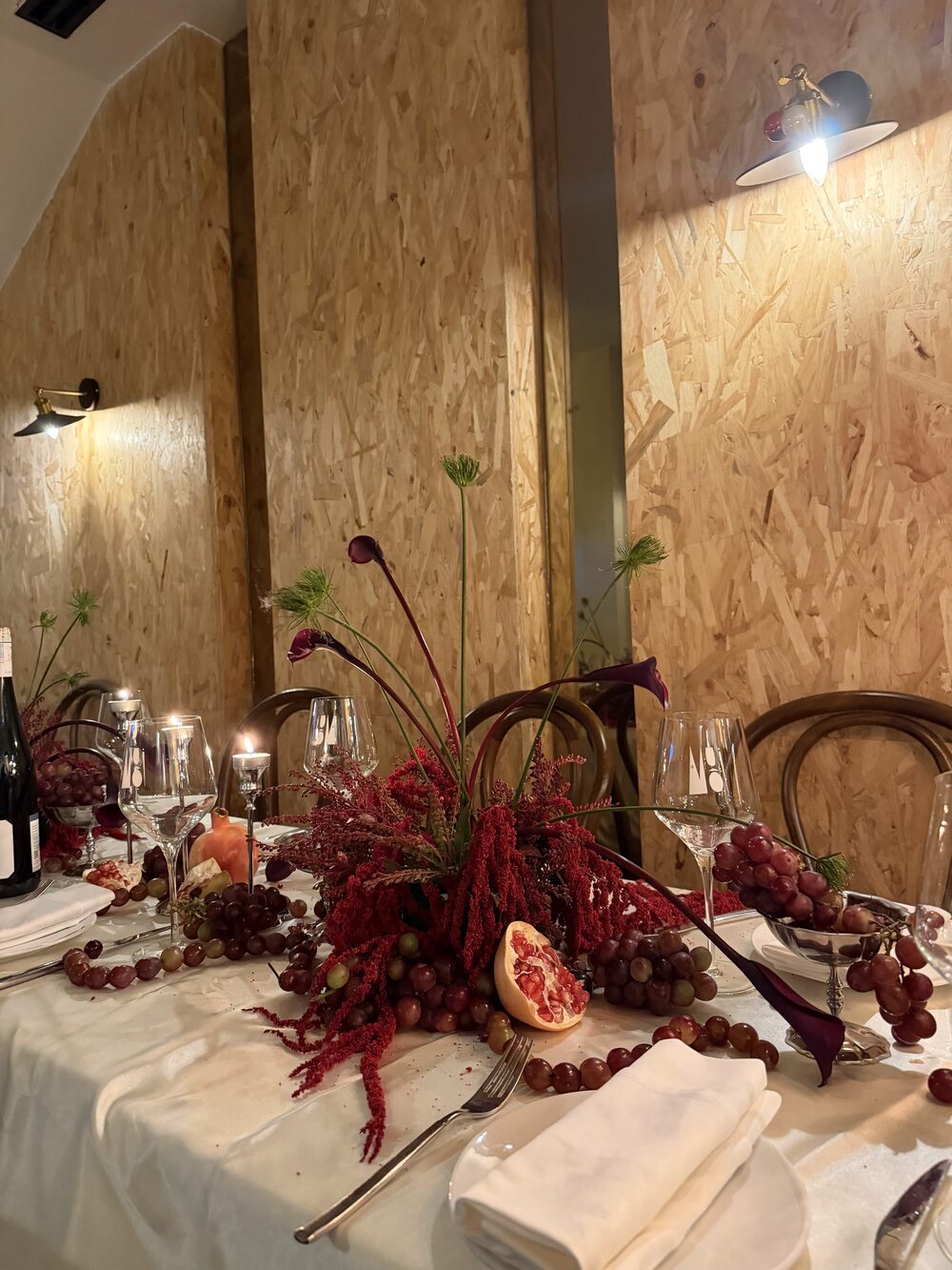 Amaranth, grapes and pomegranate centerpiece in candlelight